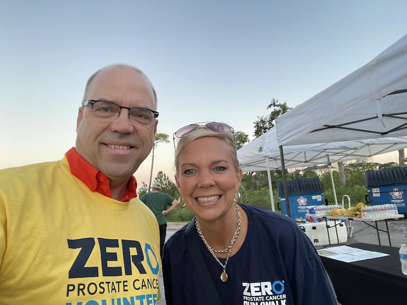 A representative from Oxford BioDynamics and a representative from ZERO Prostate Cancer smile at the camera.